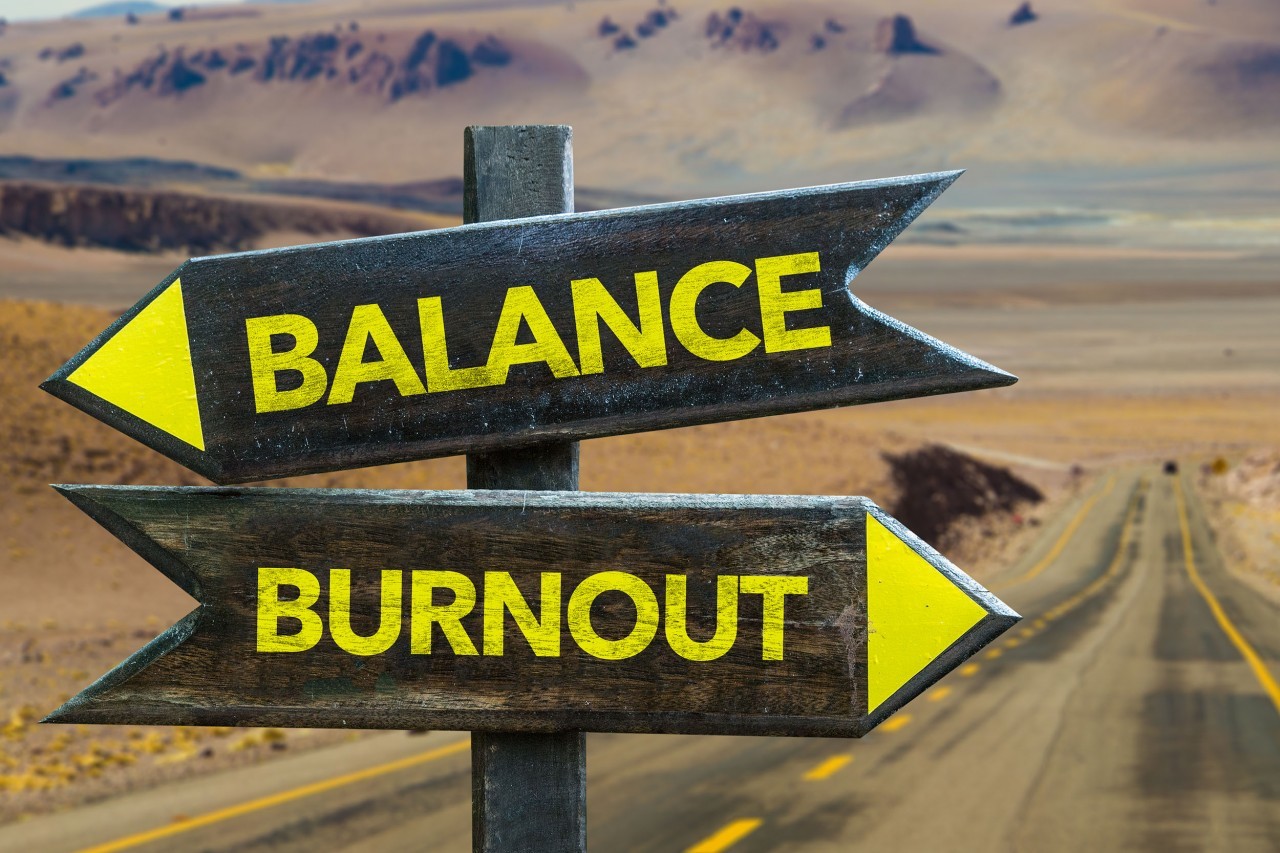 Road desert sign with 'balance' pointing left and 'burnout' pointing right